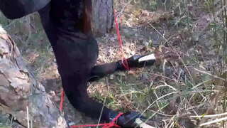 Si Laura sa mga Tikod model lakang sister sa itom nga sinina ug mga hatag-as nga tikod gigapos ug nagtakuban sa usa ka kahoy, nga magasuyop usa ka bick manok.